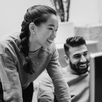 Smiling coworkers looking at screen