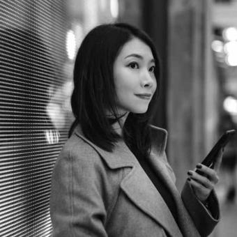 Young woman using mobile phone on the street