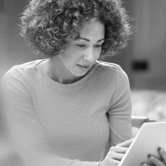 Woman filling out a form on a tablet device