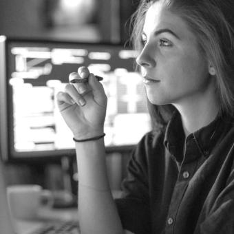 Woman with monitors in office